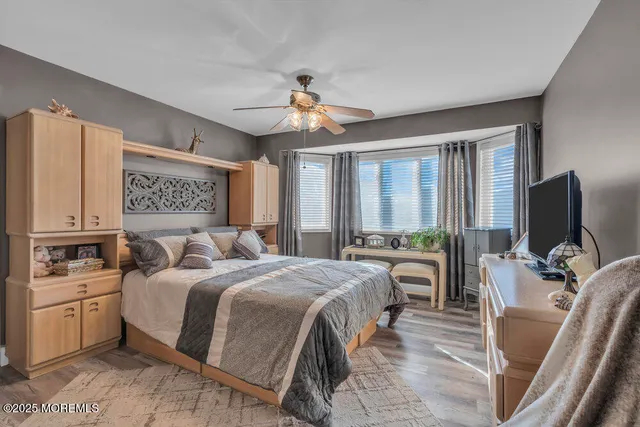 a bedroom with a bed and glass windows