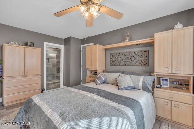 a bedroom with a large bed and a chandelier