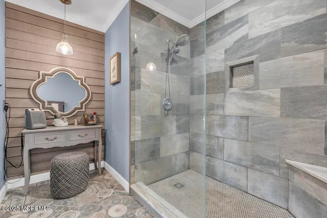 a bathroom with a mirror a sink and a shower