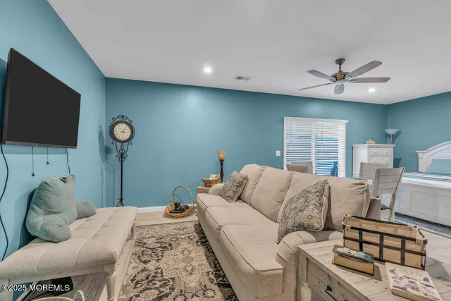 a bedroom with furniture and a flat screen tv