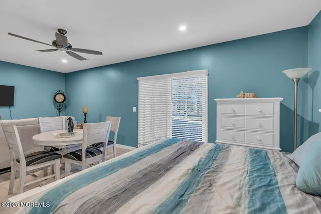 a living room with furniture and a ceiling fan