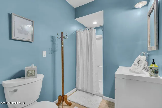 a bathroom with a toilet sink and shower