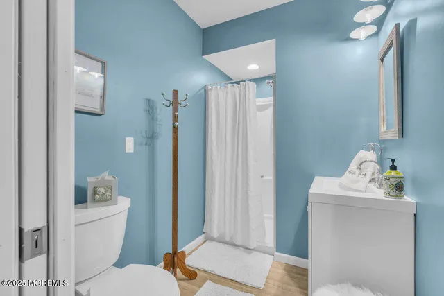 a bathroom with a toilet sink and shower