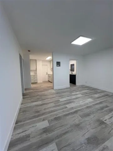 a view of a room with wooden floor and window