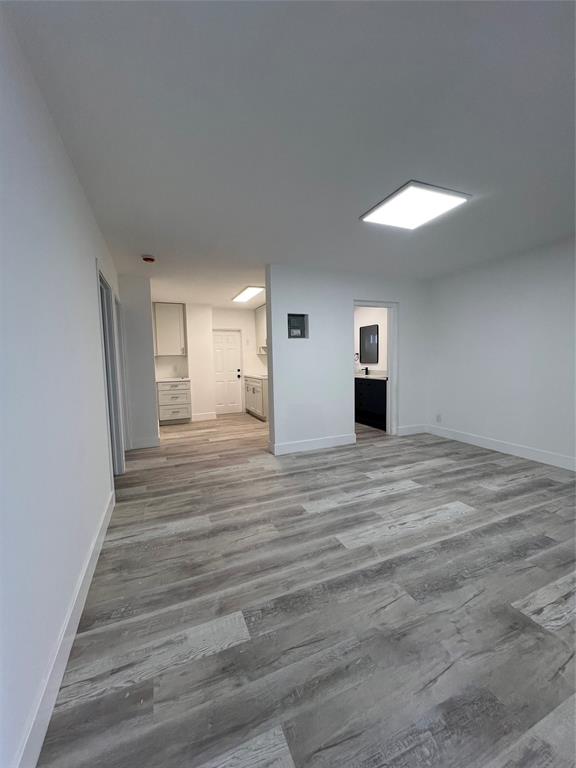 2115 North Ocean Boulevard, Unit 11 Fort Lauderdale, FL 33305 - Photo 12 of 17 a view of a room with wooden floor and window