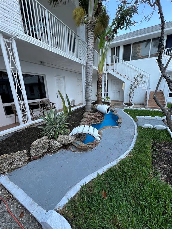 2115 North Ocean Boulevard, Unit 11 Fort Lauderdale, FL 33305 - Photo 14 of 17 a backyard of a house with outdoor seating