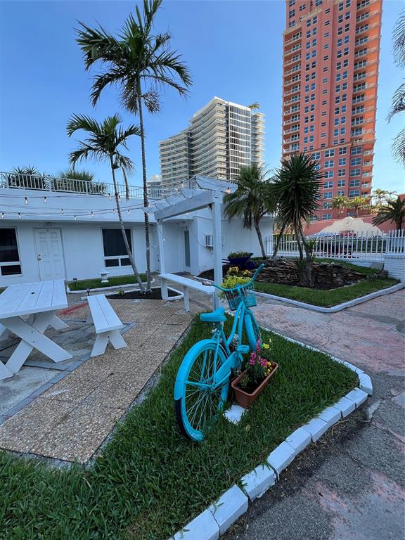 2115 North Ocean Boulevard, Unit 11 Fort Lauderdale, FL 33305 - Photo 15 of 17 a front view of a house with garden