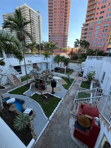 a view of a backyard with plants and patio