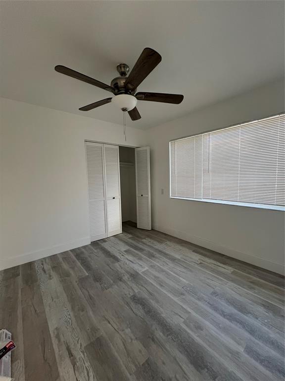 2115 North Ocean Boulevard, Unit 11 Fort Lauderdale, FL 33305 - Photo 7 of 17 a view of an empty room with wooden floor and a window