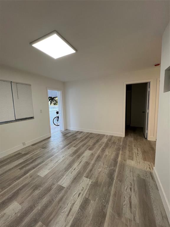 2115 North Ocean Boulevard, Unit 11 Fort Lauderdale, FL 33305 - Photo 8 of 17 a view of empty room with wooden floor