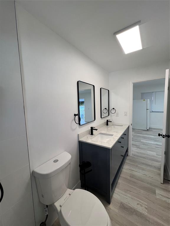 2115 North Ocean Boulevard, Unit 11 Fort Lauderdale, FL 33305 - Photo 9 of 17 a bathroom with a sink mirror vanity and toilet