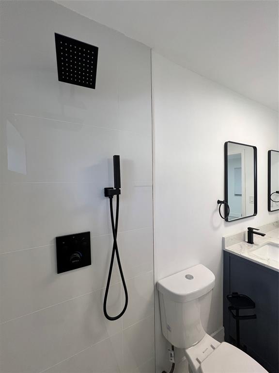 2115 North Ocean Boulevard, Unit 11 Fort Lauderdale, FL 33305 - Photo 10 of 17 a bathroom with a toilet sink and shower