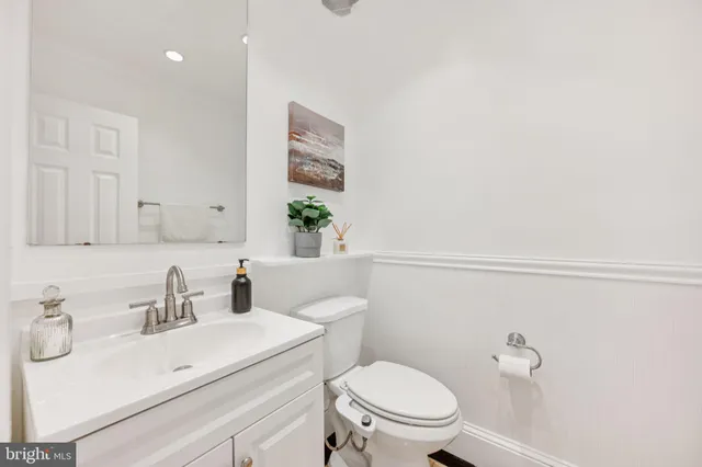 a bathroom with a sink a toilet and vanity