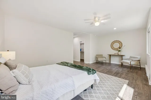 a bedroom with a large bed and a chandelier