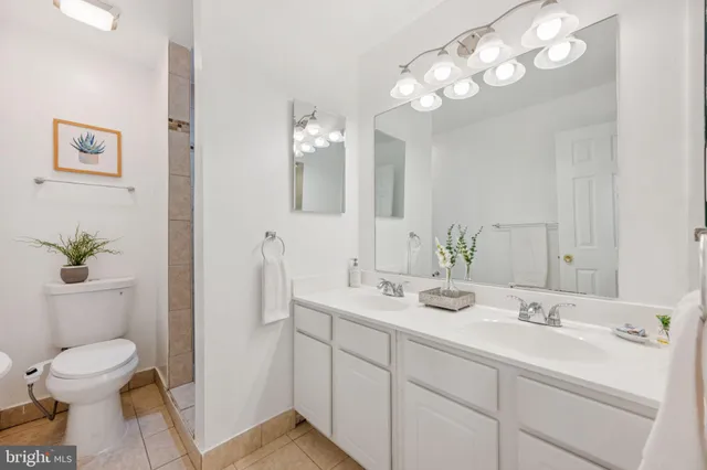 a bathroom with a toilet a sink and a mirror