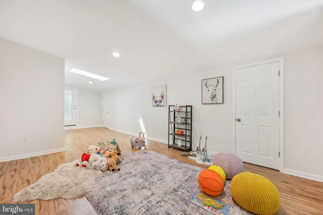 a view of a room with wooden floor and furniture
