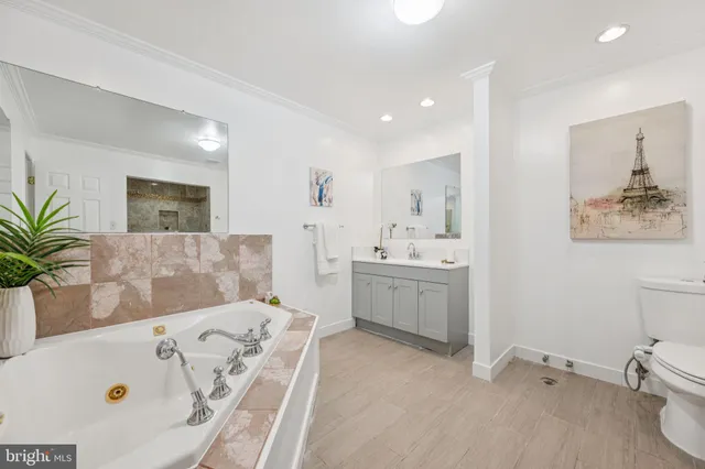 a bathroom with a tub sink and mirror