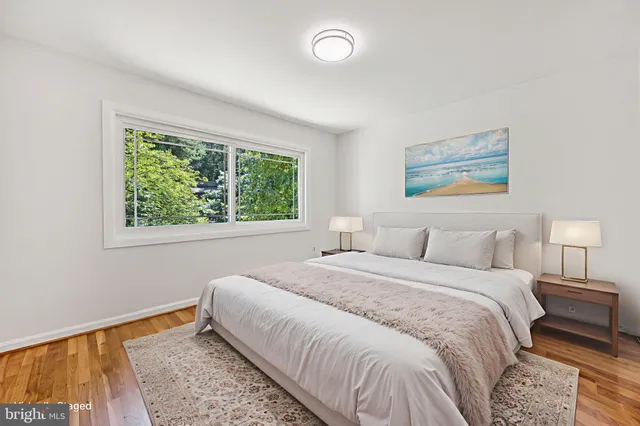 a bedroom with a bed and a painting on the wall