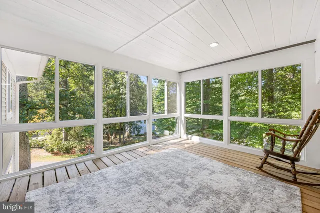 an empty room with large windows