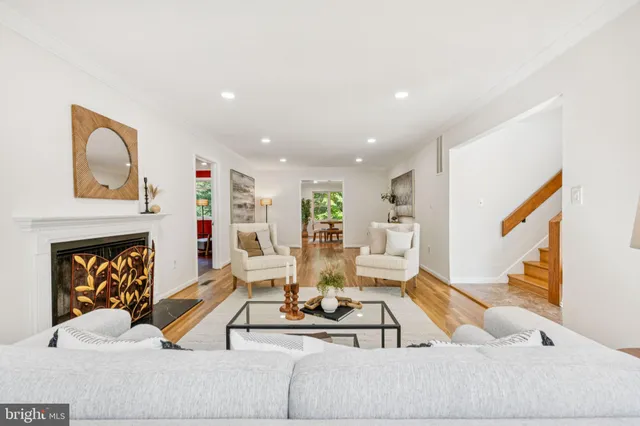 a living room with furniture kitchen view and a fireplace