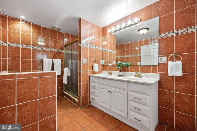a bathroom with a double vanity sink mirror and