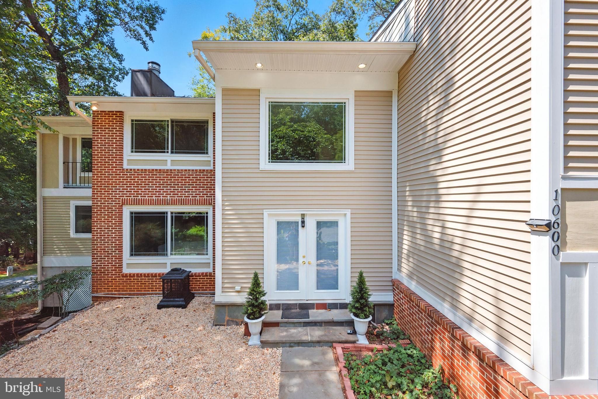 10600 Vantage Court Potomac, MD 20854 - Photo 36 of 51 a front view of a house with a garden and seating area
