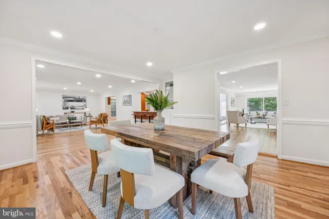a dining room with furniture and wooden floor