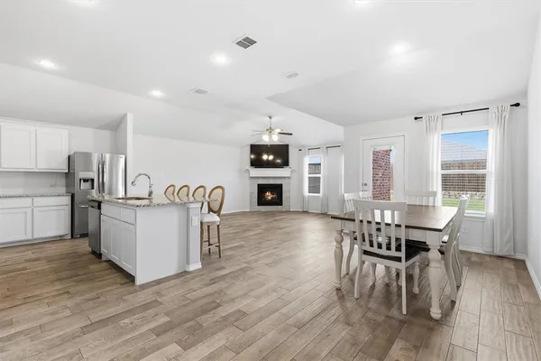 a dining room with furniture and wooden floor
