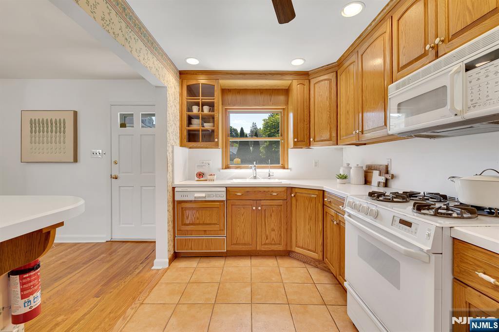287 Jackson Avenue Rutherford, NJ 07070 - Photo 11 of 36 a kitchen with a stove a sink and a refrigerator
