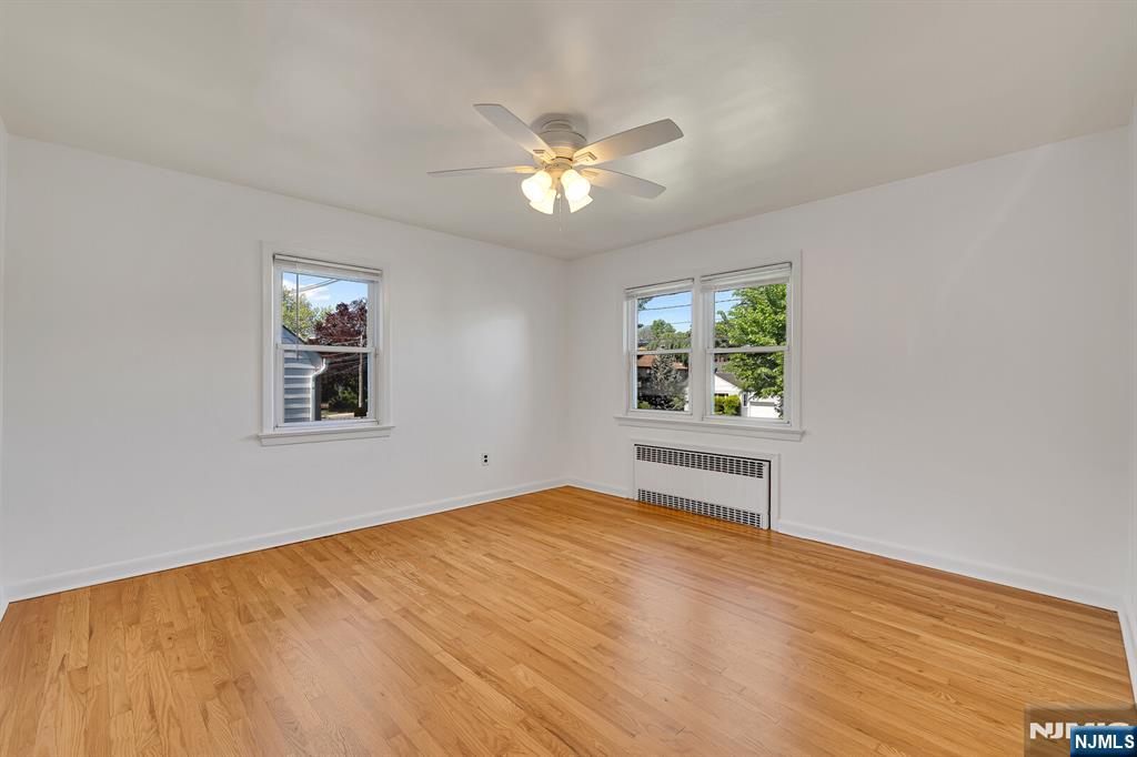 287 Jackson Avenue Rutherford, NJ 07070 - Photo 12 of 36 a view of empty room with wooden floor and fan
