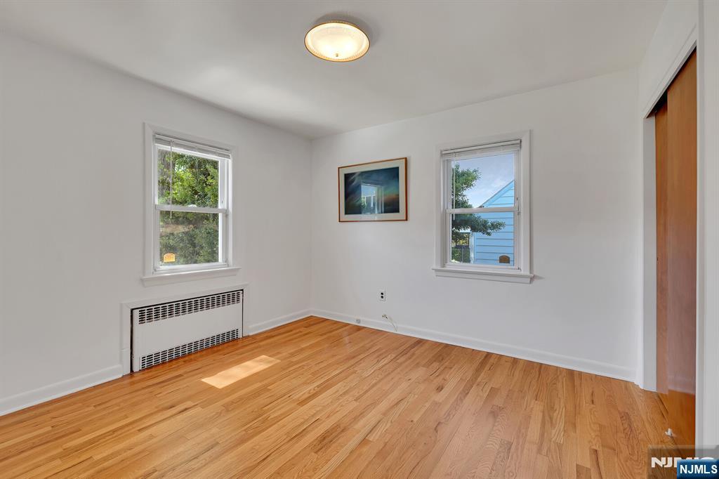 287 Jackson Avenue Rutherford, NJ 07070 - Photo 14 of 36 a view of empty room with wooden floor and fan