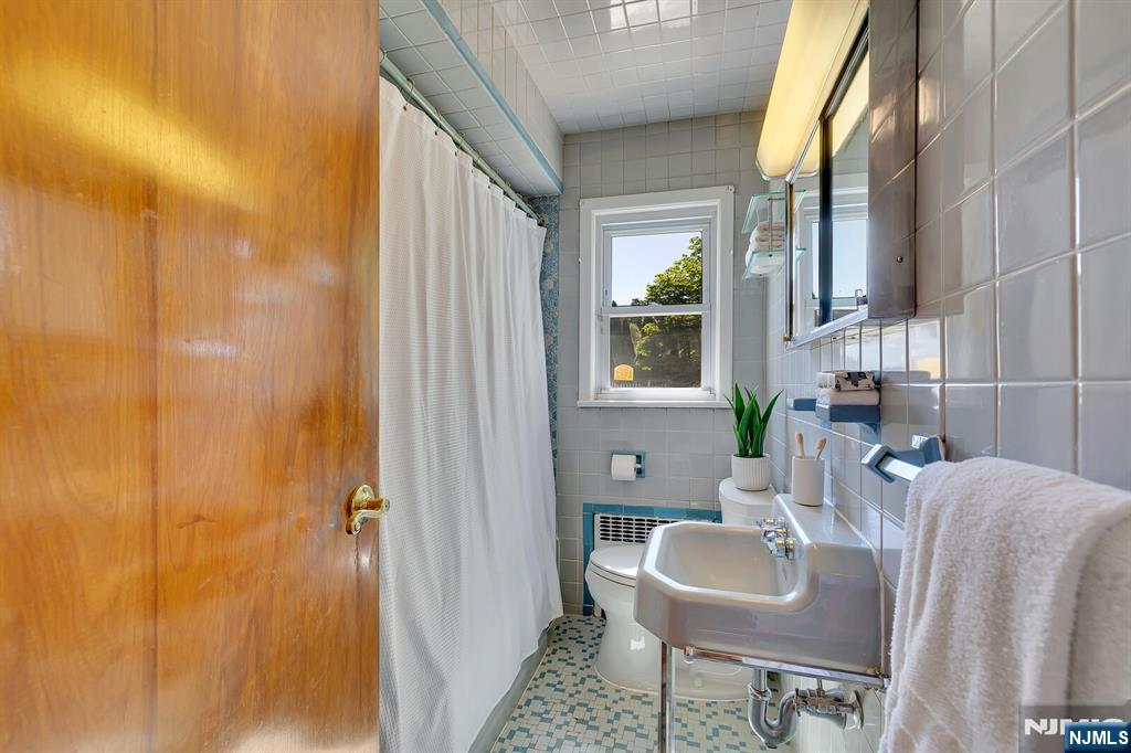287 Jackson Avenue Rutherford, NJ 07070 - Photo 15 of 36 a bathroom with a sink and a mirror