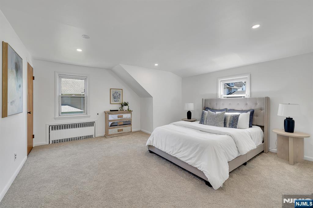 287 Jackson Avenue Rutherford, NJ 07070 - Photo 17 of 36 a spacious bedroom with a bed and a cabinets