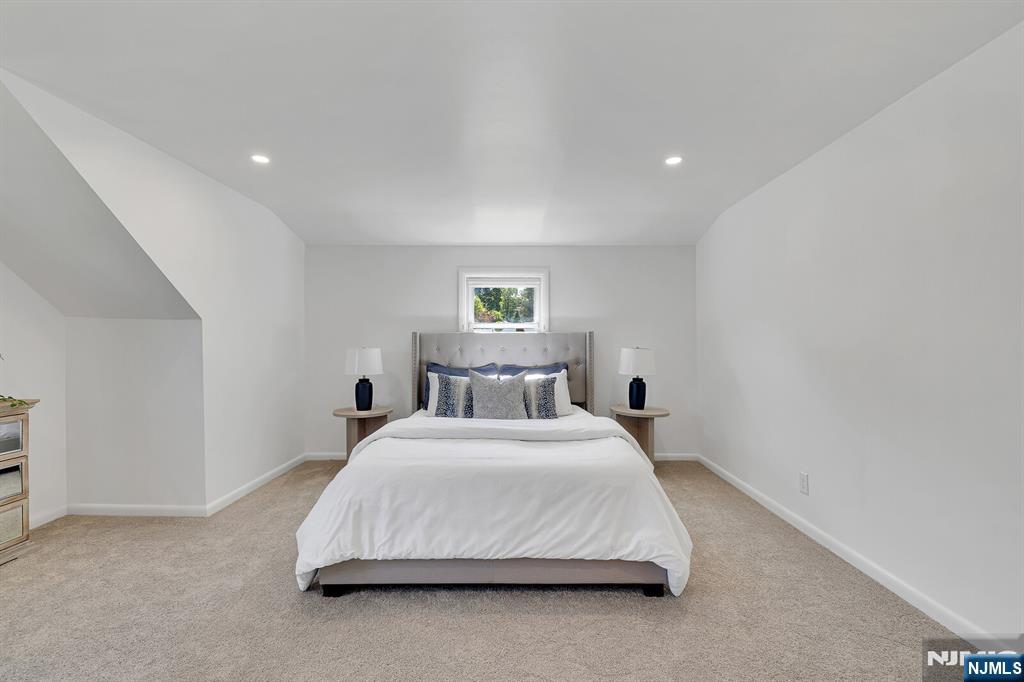 287 Jackson Avenue Rutherford, NJ 07070 - Photo 19 of 36 a bedroom with a bed and window