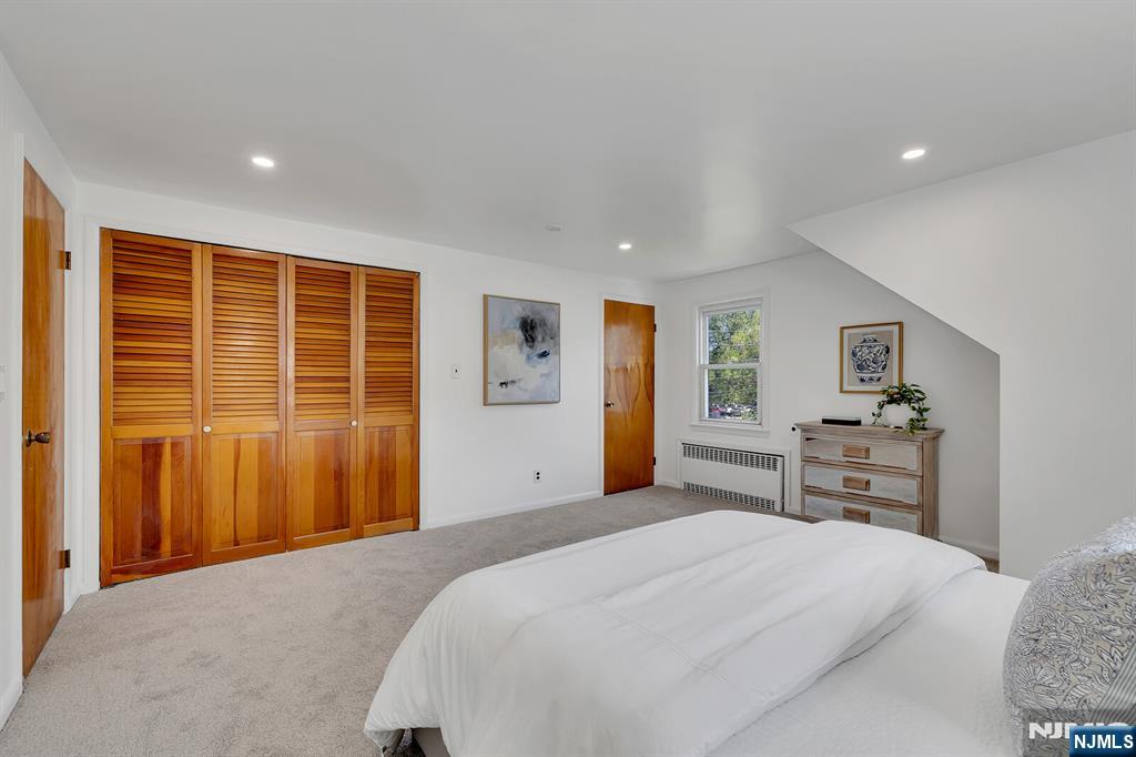 287 Jackson Avenue Rutherford, NJ 07070 - Photo 20 of 36 a bedroom with a bed and wooden floor