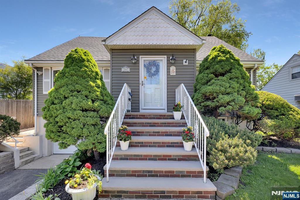 287 Jackson Avenue Rutherford, NJ 07070 - Photo 2 of 36 a front view of a house with a garden