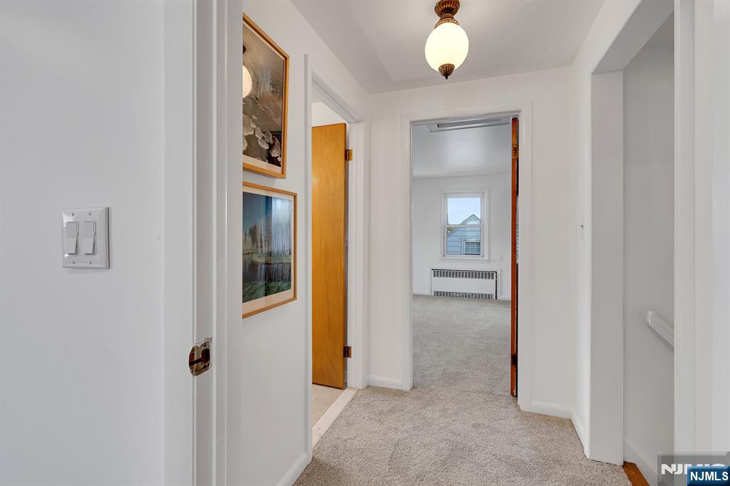 287 Jackson Avenue Rutherford, NJ 07070 - Photo 22 of 36 a view of a hallway with wooden floor and cabinet