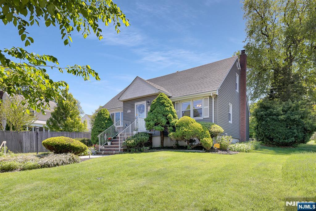 287 Jackson Avenue Rutherford, NJ 07070 - Photo 34 of 36 a front view of a house with a yard and garage