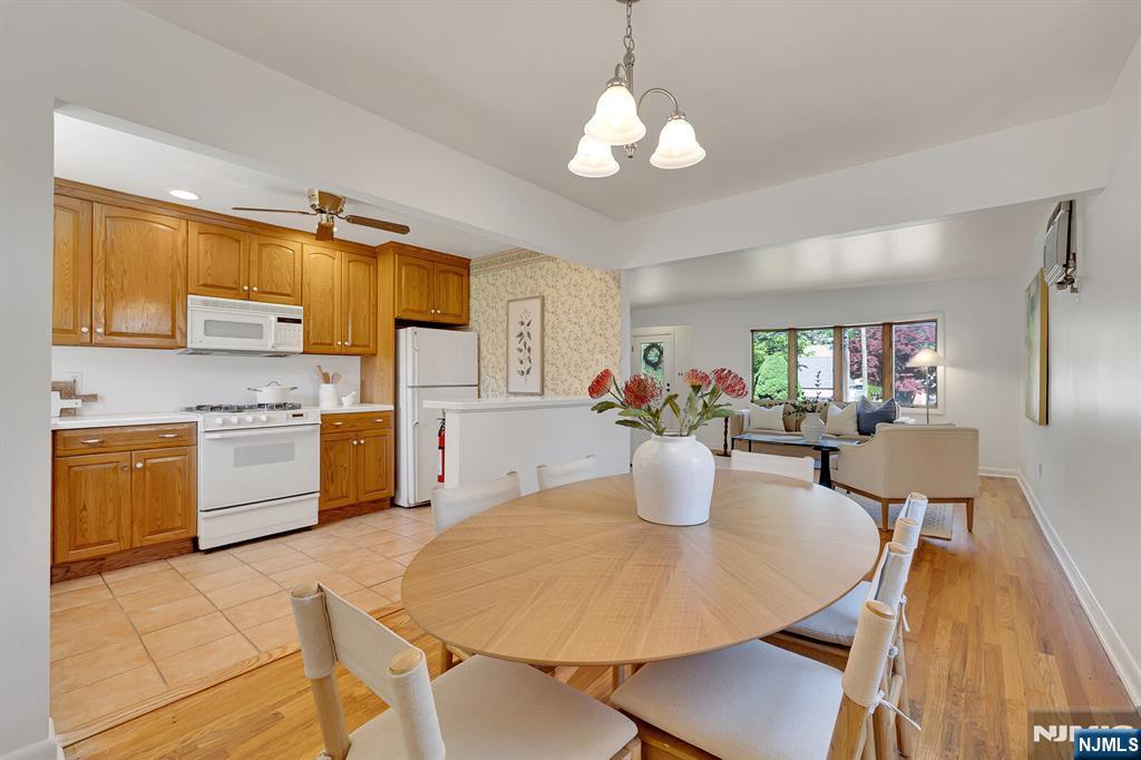 287 Jackson Avenue Rutherford, NJ 07070 - Photo 9 of 36 a kitchen with a table chairs and white cabinets
