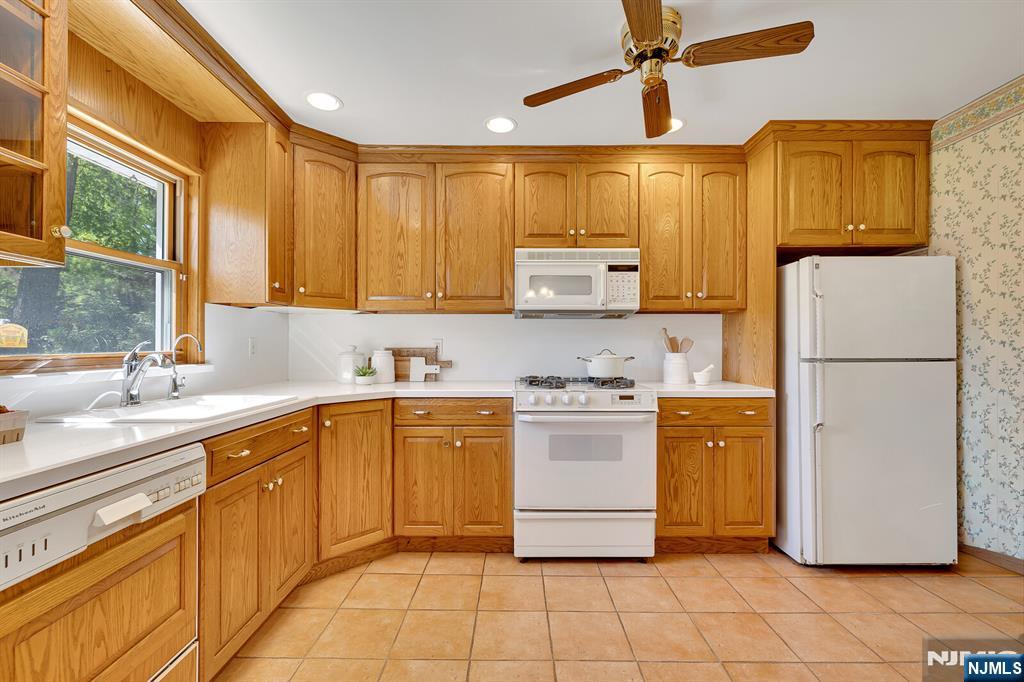 287 Jackson Avenue Rutherford, NJ 07070 - Photo 10 of 36 a kitchen with stainless steel appliances granite countertop a refrigerator sink and stove