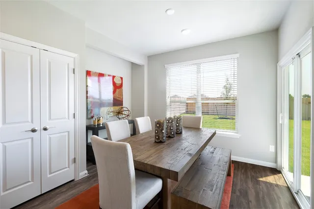 a dining room with furniture and wooden floor