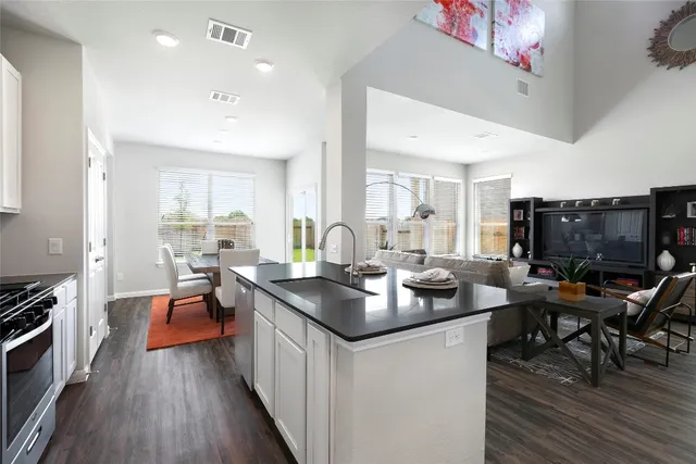 a living room with furniture and a dining table