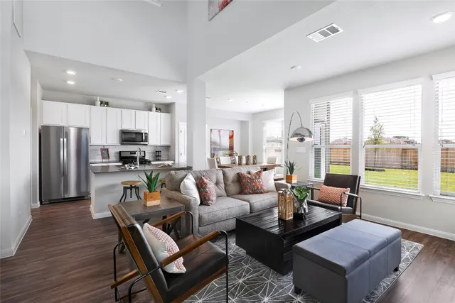 a kitchen with stainless steel appliances a refrigerator a sink a stove a microwave and cabinets