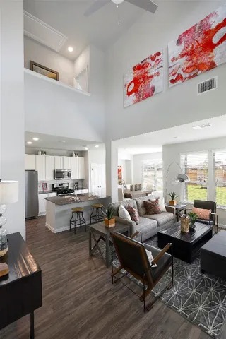 a kitchen with stainless steel appliances granite countertop a stove top oven a sink dishwasher a dining table and chairs with wooden floor