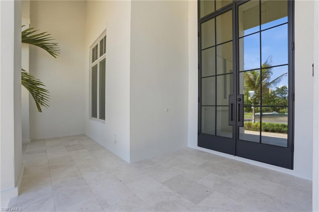 4851 Crayton Road Naples, FL 34103 - Photo 3 of 33 an empty room with windows