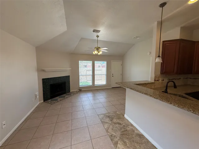a view of a kitchen with a sink and a fireplace