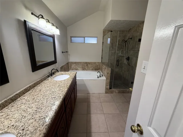 a bathroom with a granite countertop sink mirror and vanity
