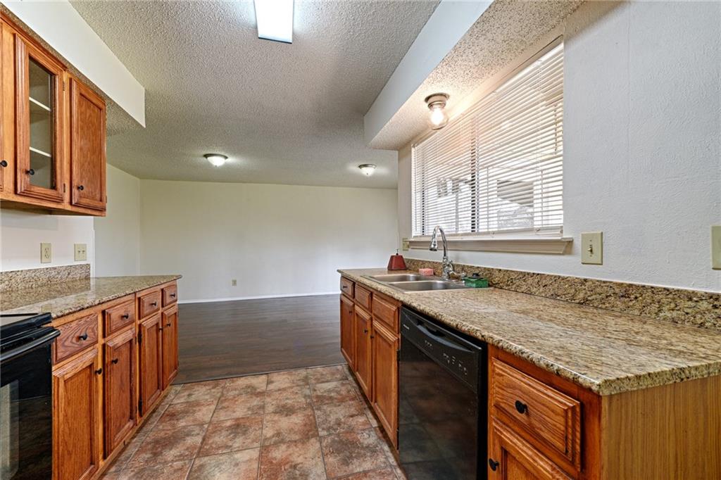 4652 Misty Ridge Drive Fort Worth, TX 76137 - Photo 11 of 24 a kitchen with granite countertop a sink and a stove