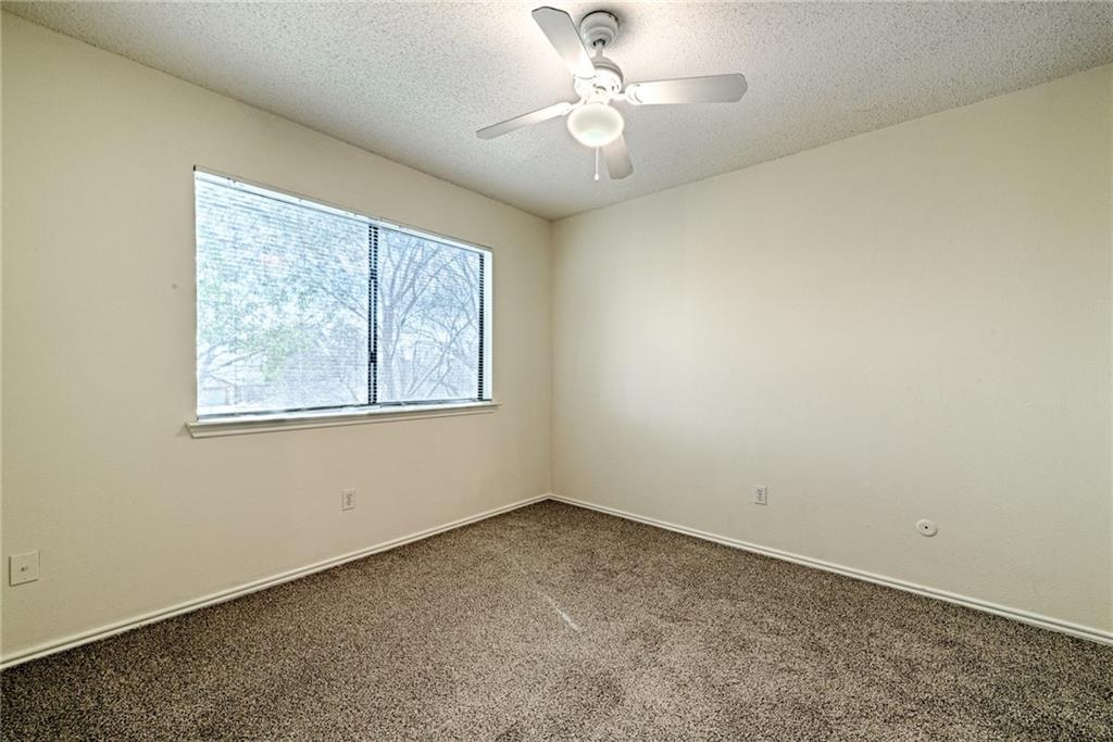 4652 Misty Ridge Drive Fort Worth, TX 76137 - Photo 17 of 24 an empty room with windows and fan