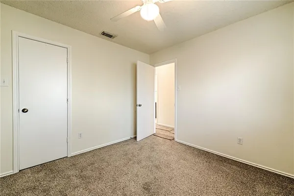 an empty room with a ceiling fan